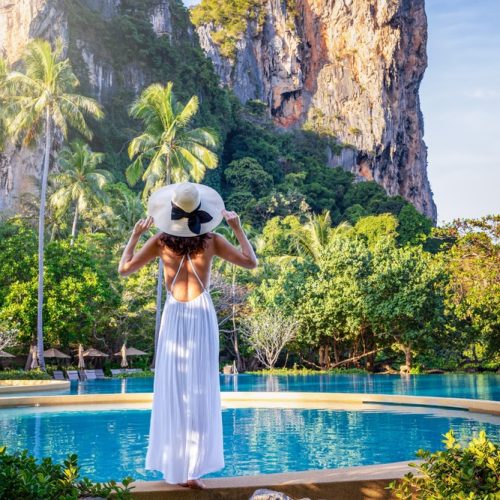 A,Tourist,Woman,In,A,White,Dress,Looking,At,The