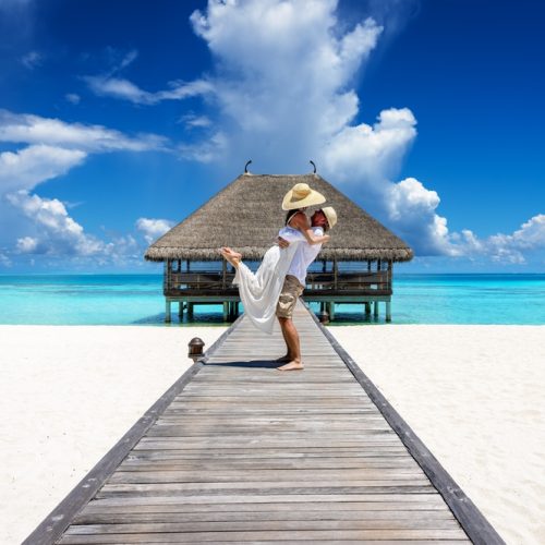 A,Happy,Couple,In,White,Summer,Clothing,Hugging,On,A